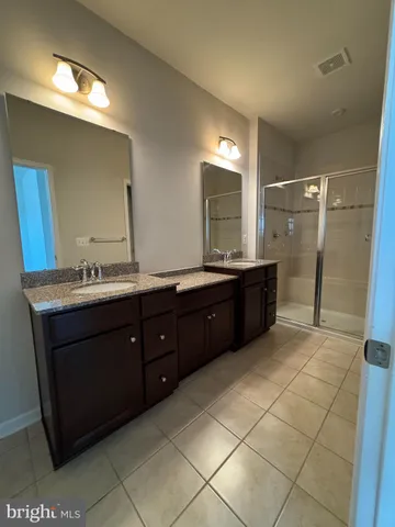 a bathroom with a granite countertop sink mirror and double