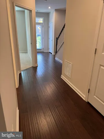 a view of a hallway with wooden floor