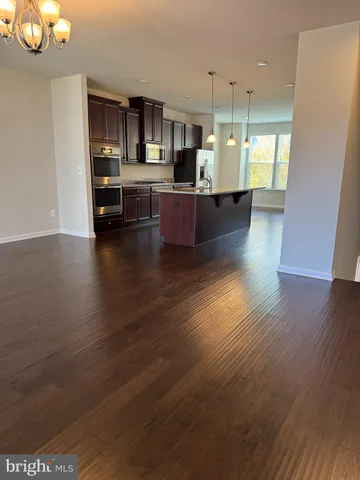 a view of kitchen with furniture and wooden floor