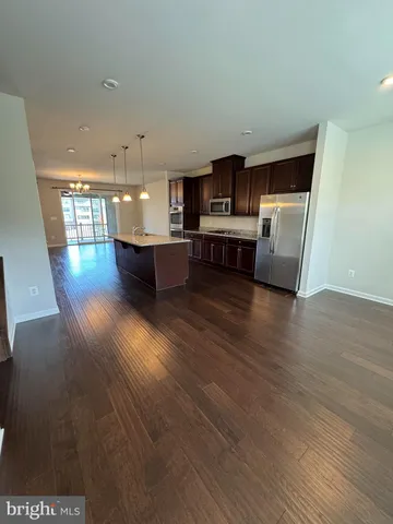 a view of kitchen with microwave and cabinets