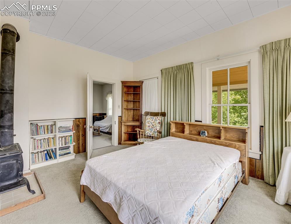 2 County Road 81 Victor, CO 80860 - Photo 19 of 28 a spacious bedroom with a bed and a large window