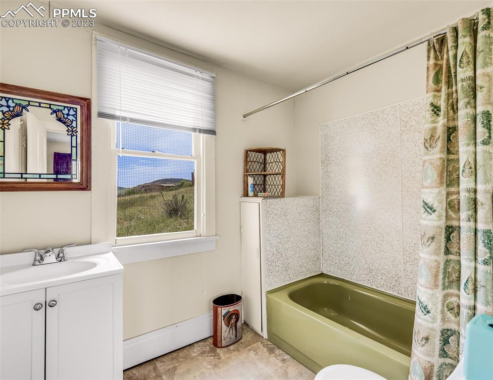 2 County Road 81 Victor, CO 80860 - Photo 21 of 28 a bathroom with a tub a sink and a window