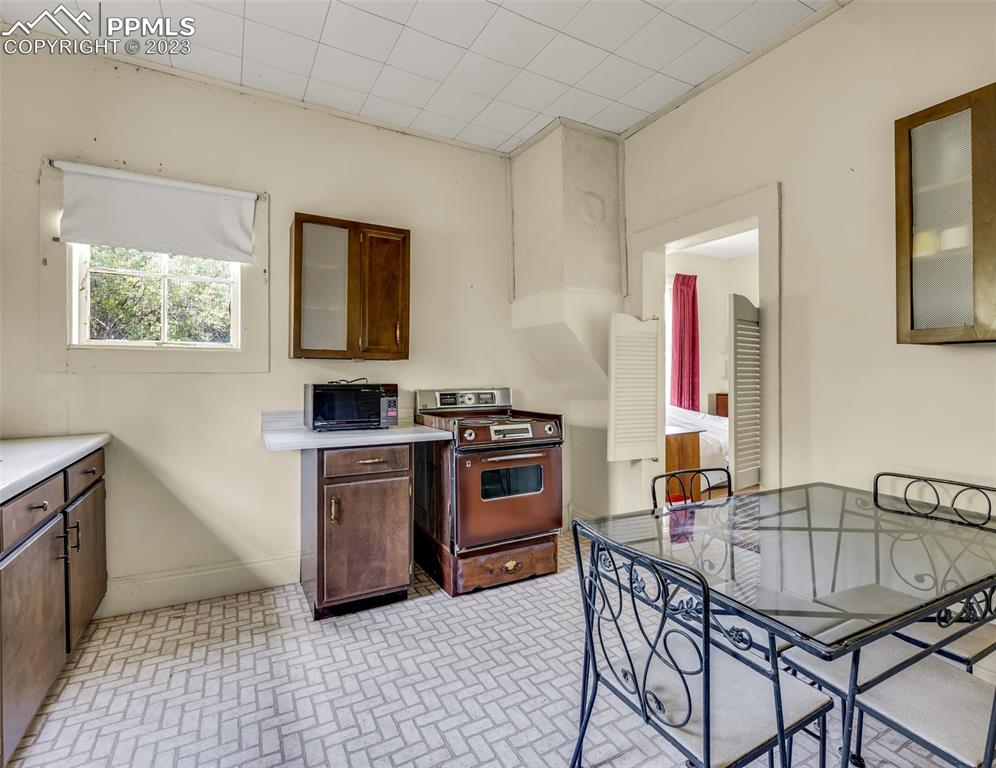 2 County Road 81 Victor, CO 80860 - Photo 26 of 28 a kitchen with a stove a sink and a refrigerator