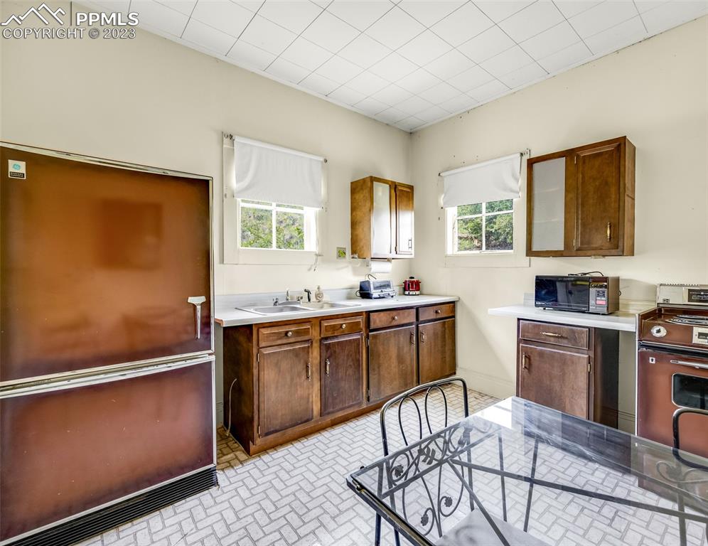 2 County Road 81 Victor, CO 80860 - Photo 27 of 28 a kitchen with stainless steel appliances granite countertop a refrigerator sink and stove