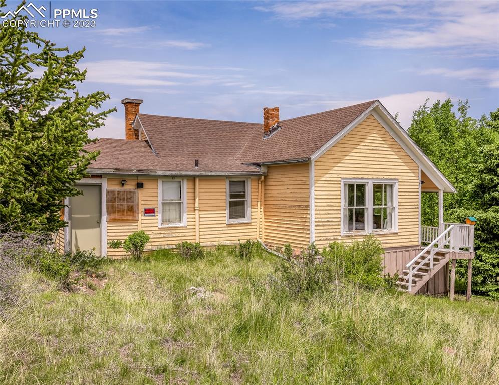 2 County Road 81 Victor, CO 80860 - Photo 4 of 28 a view of a house with large windows and a yard