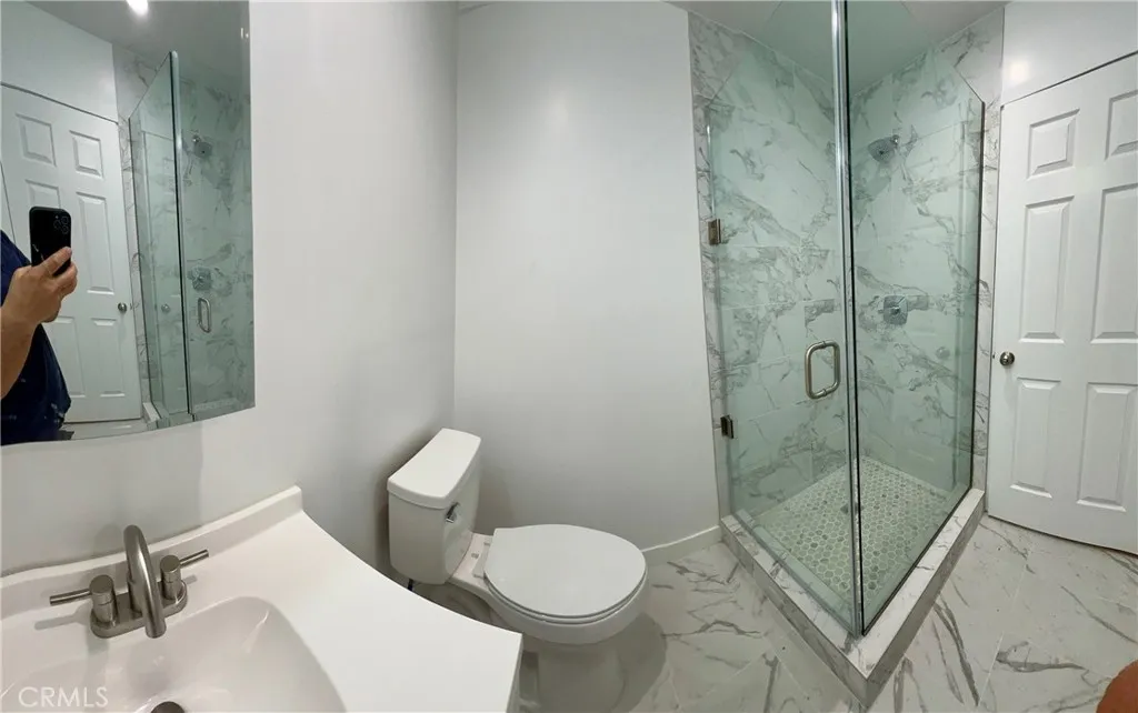 18654 Runnymede Street Reseda, CA 91335 - Photo 5 of 12 a bathroom with a toilet sink and shower