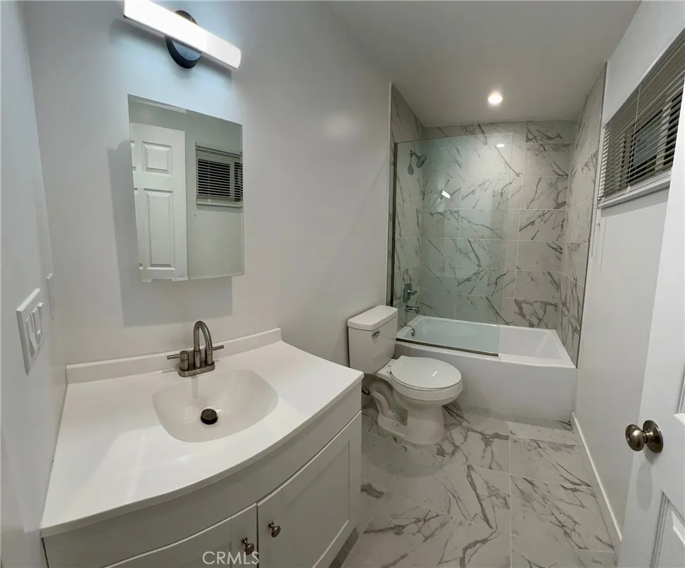 18654 Runnymede Street Reseda, CA 91335 - Photo 8 of 12 a bathroom with a sink toilet and shower