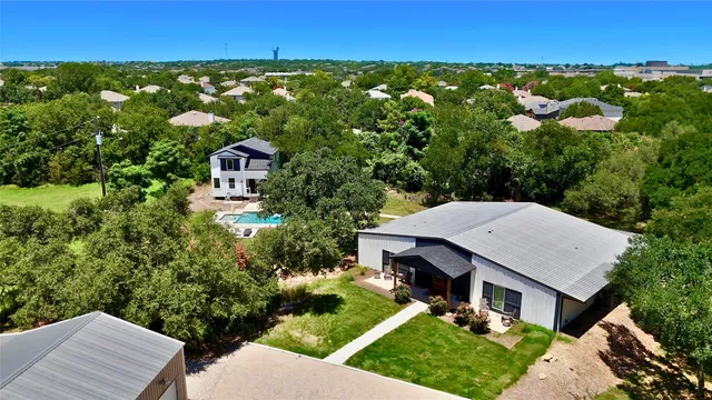 an aerial view of a house with garden space and street view