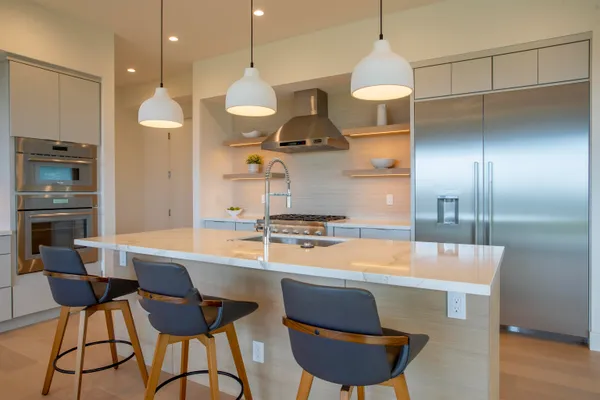 a large kitchen with a large window and furniture
