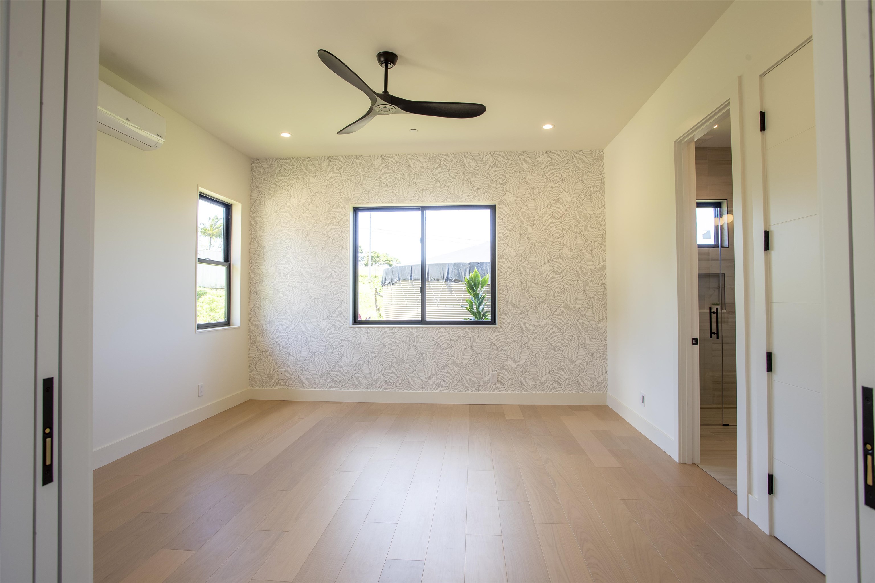 111 Mehana Road, Unit A Haiku, HI 96708 - Photo 21 of 41 a view of empty room with wooden floor and fan