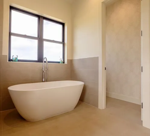 a white bath tub sitting next to a window