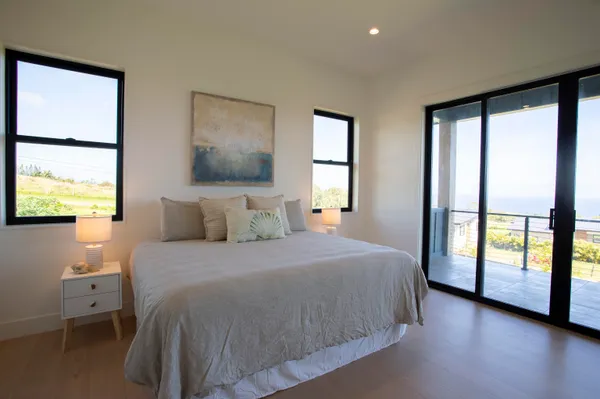a spacious bedroom with a large bed and a large window