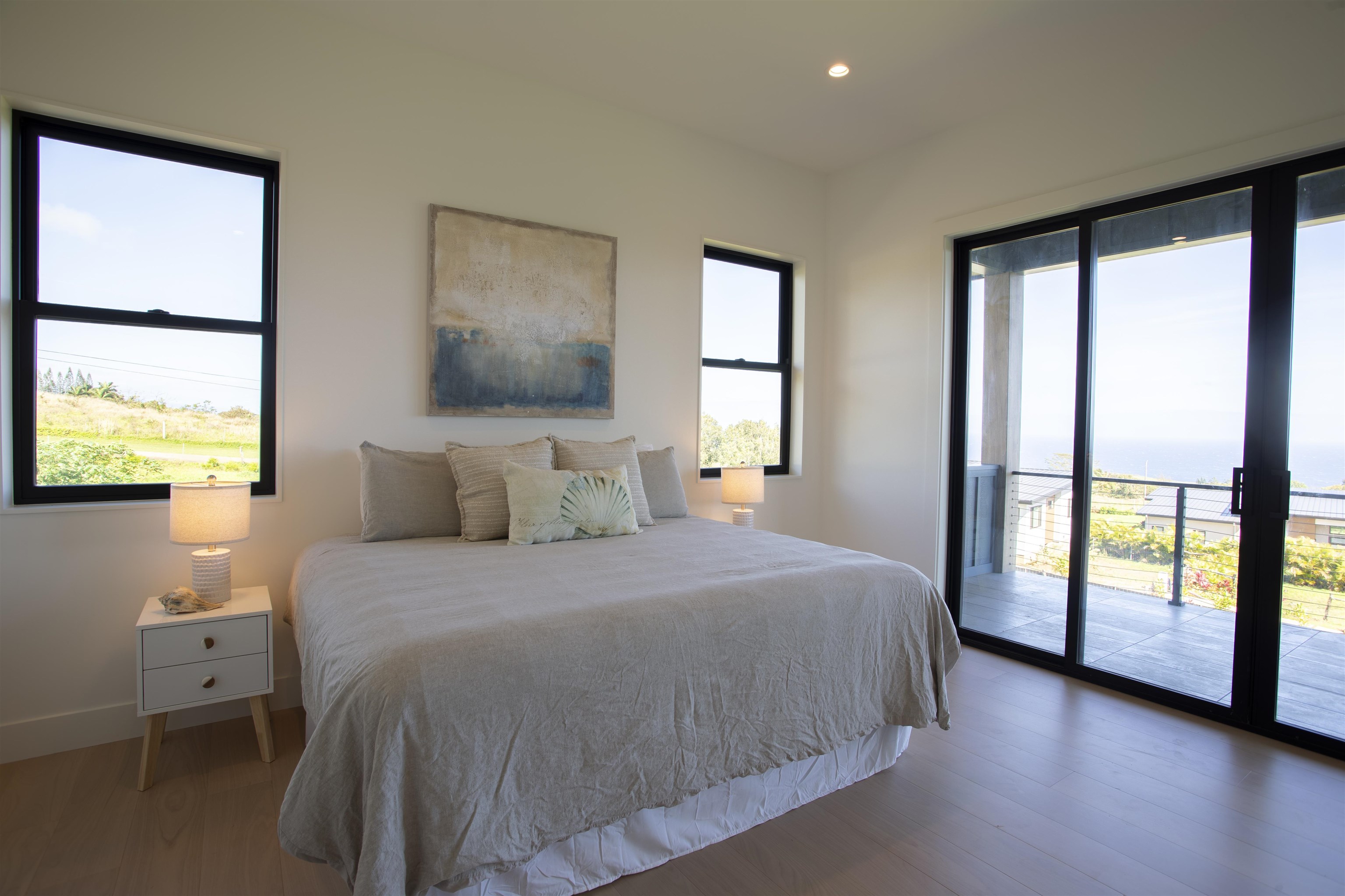 111 Mehana Road, Unit A Haiku, HI 96708 - Photo 29 of 41 a bedroom with a large bed and a tv