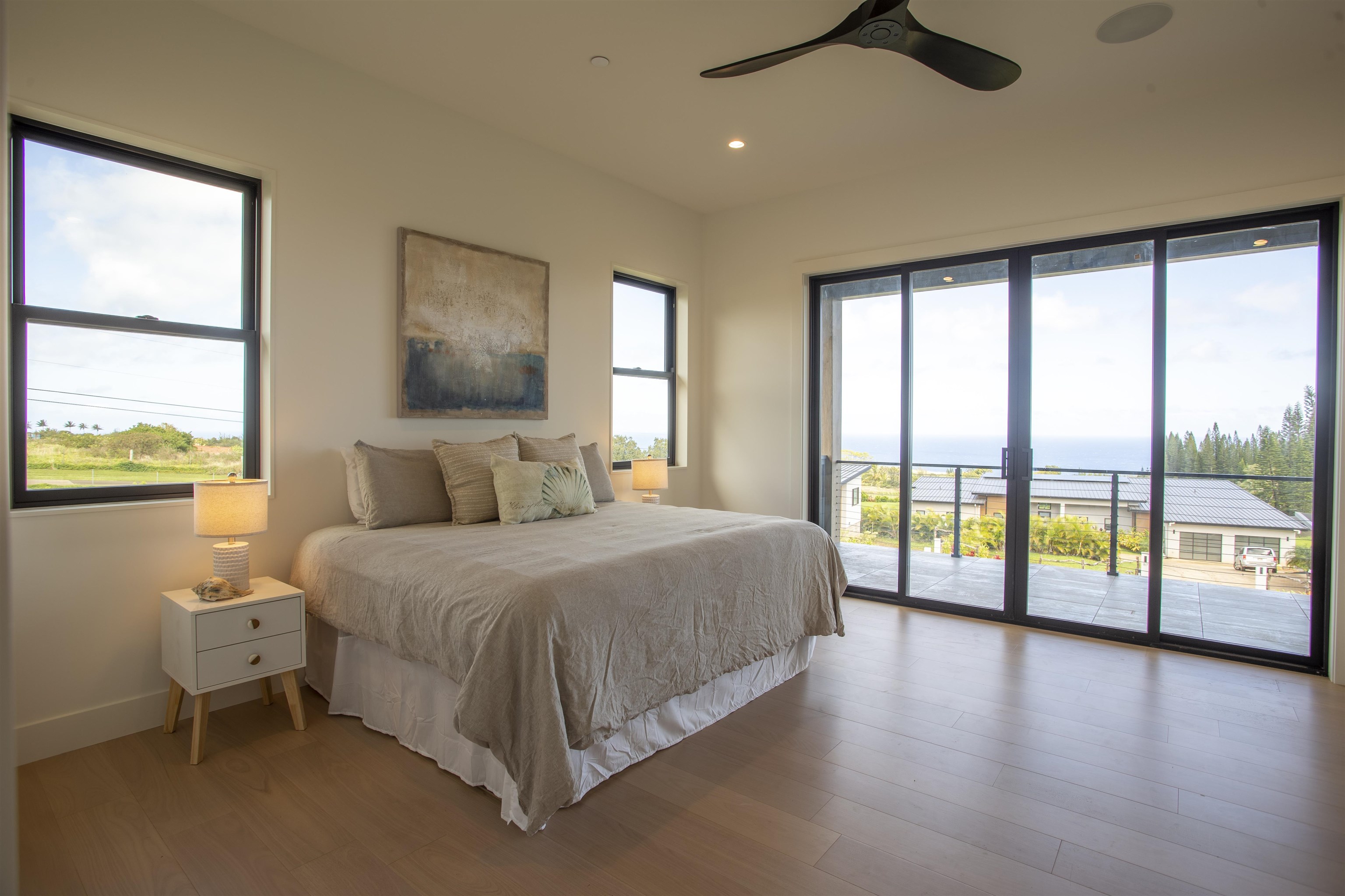 111 Mehana Road, Unit A Haiku, HI 96708 - Photo 30 of 41 a spacious bedroom with a large bed and a large window