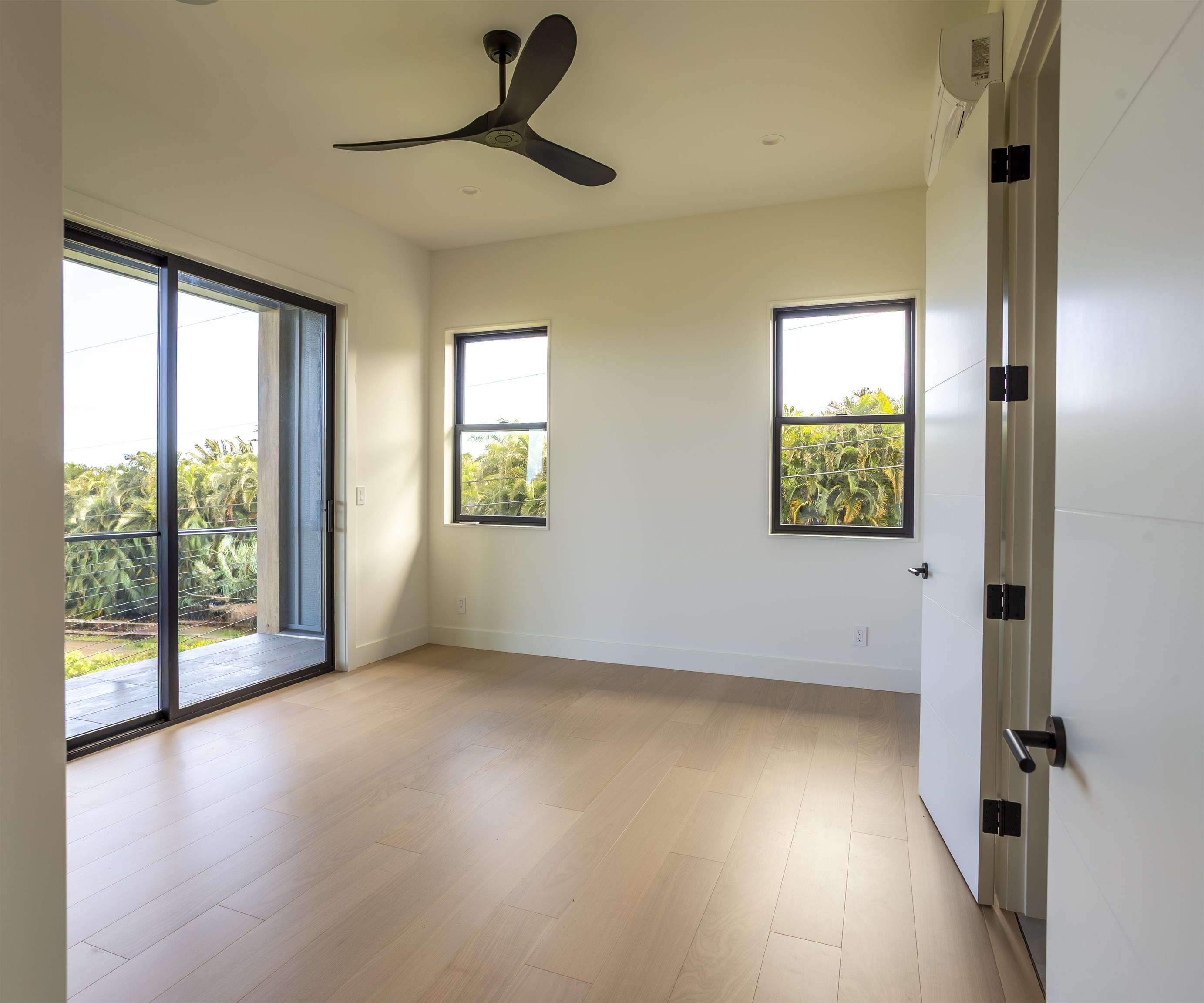 111 Mehana Road, Unit A Haiku, HI 96708 - Photo 32 of 41 wooden floor in an empty room with a window