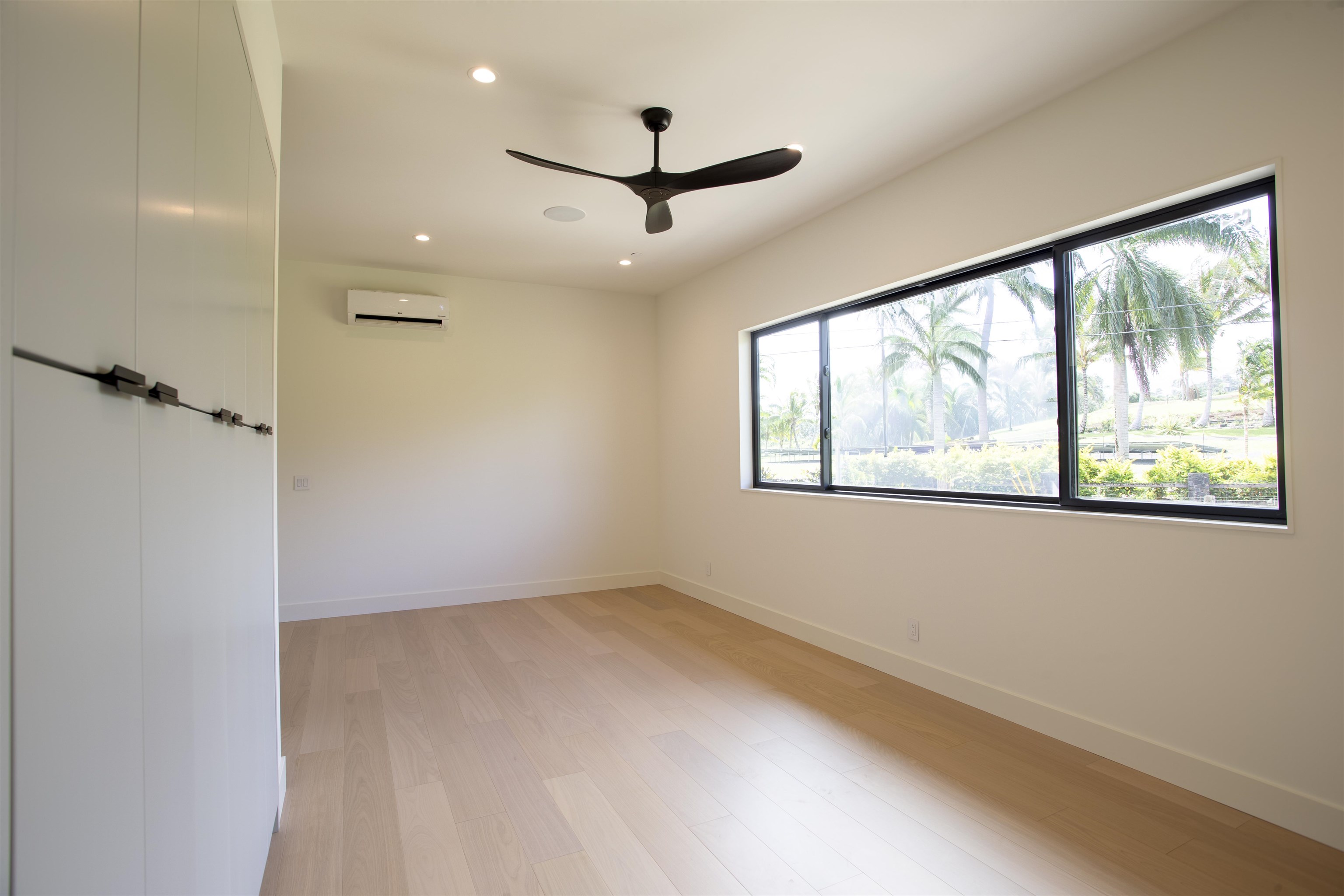 111 Mehana Road, Unit A Haiku, HI 96708 - Photo 40 of 41 wooden floor in an empty room with a window