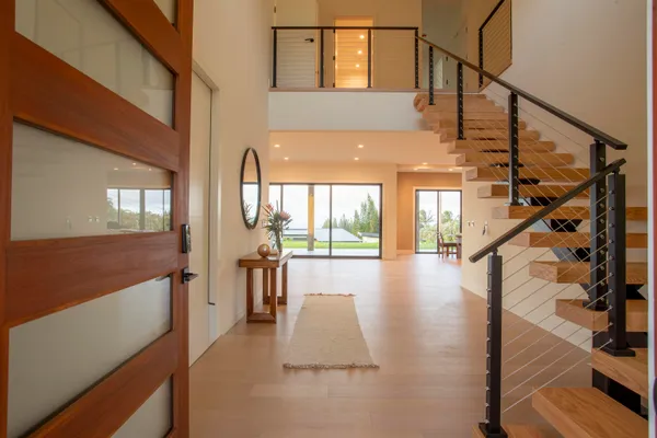 a view of entryway and hall with wooden floor