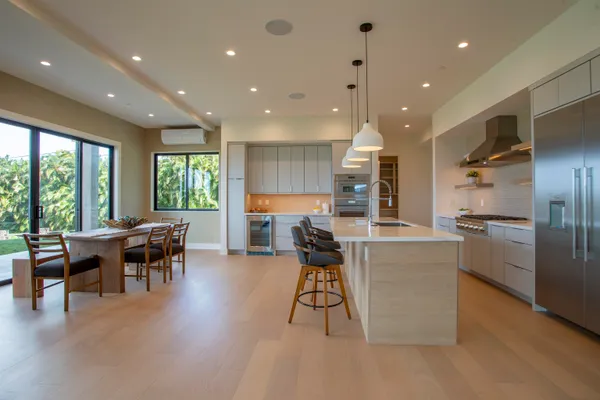 a large kitchen with a table and chairs