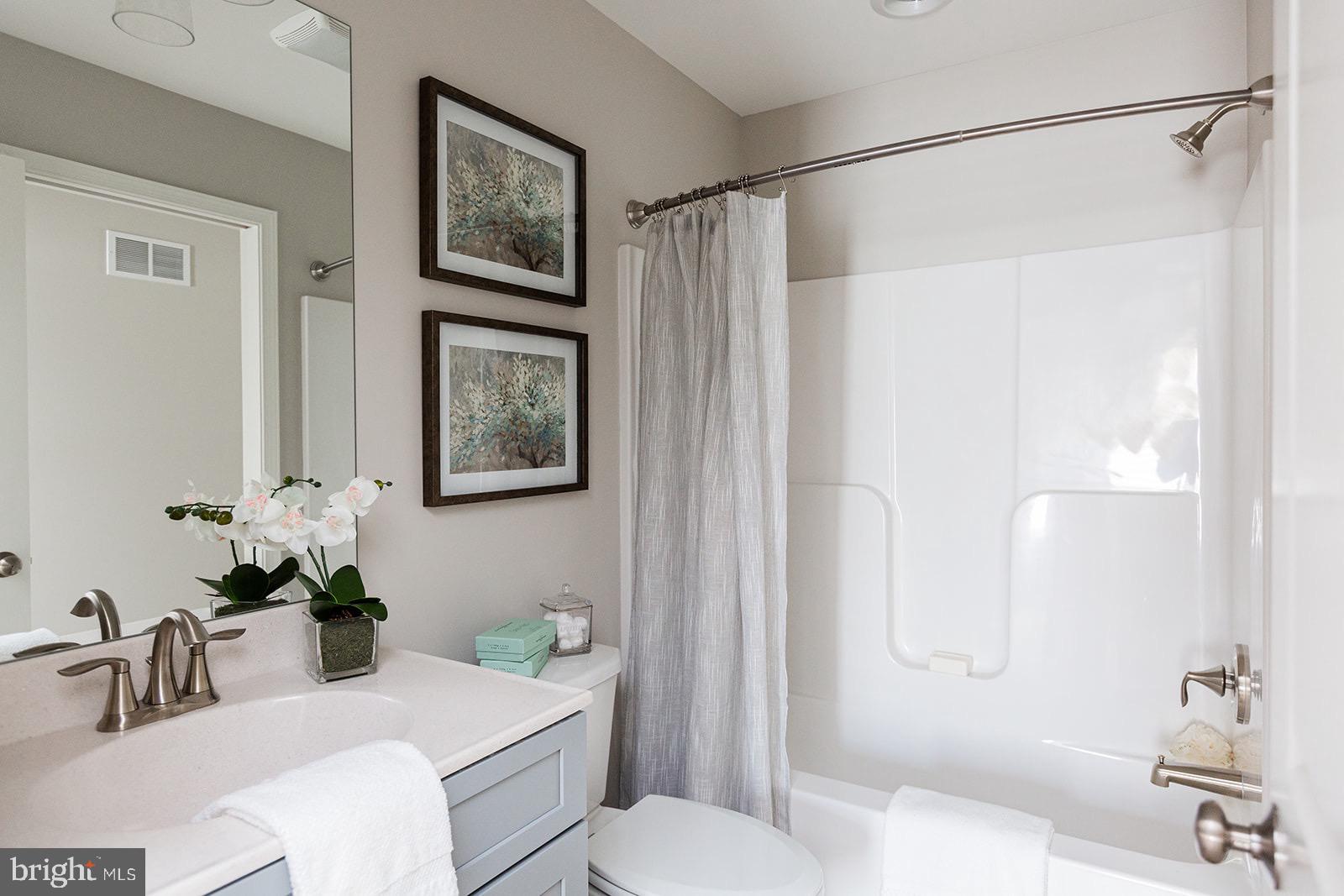 Wickmere Street, Unit F Oxford, PA 19363 - Photo 42 of 43 a bathroom with a sink vanity mirror and toilet