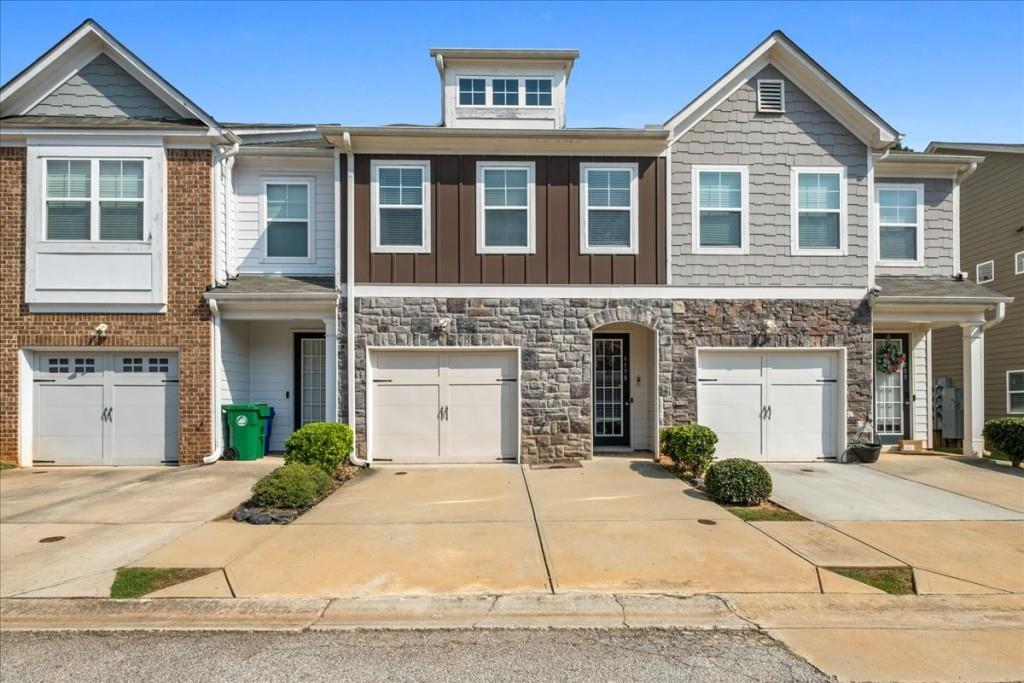 4998 Longview Walk Decatur, GA 30035 - Photo 2 of 29 a front view of a house with a yard and garage