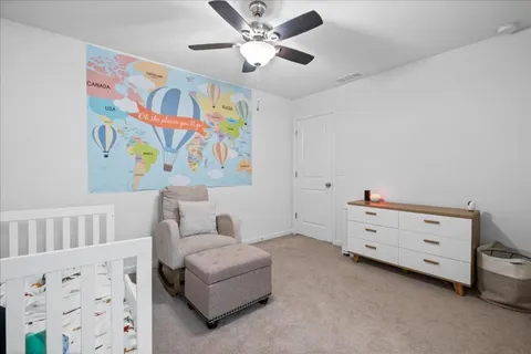 a bedroom with furniture and a baby crib