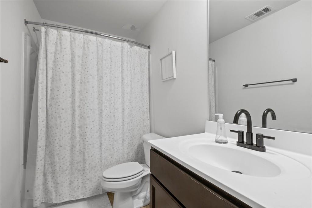 4998 Longview Walk Decatur, GA 30035 - Photo 26 of 29 a bathroom with a sink a toilet and a mirror