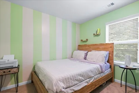 a bedroom with a bed and a chair