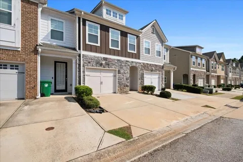 a front view of a building with a garden