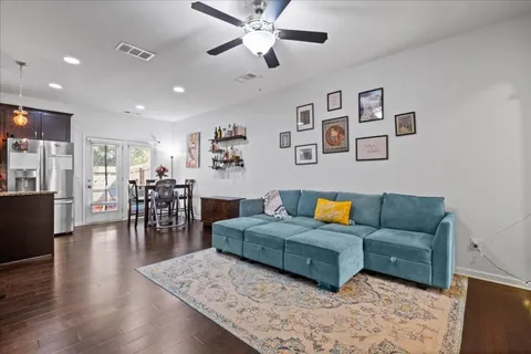 a living room with furniture and wooden floor