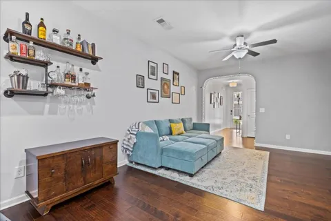 a living room with furniture and wooden floor