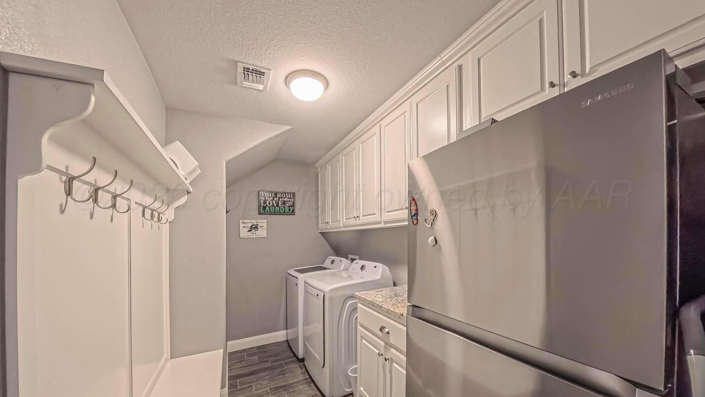 8903 Canton Court Amarillo, TX 79119 - Photo 13 of 26 a utility room with dryer and washer