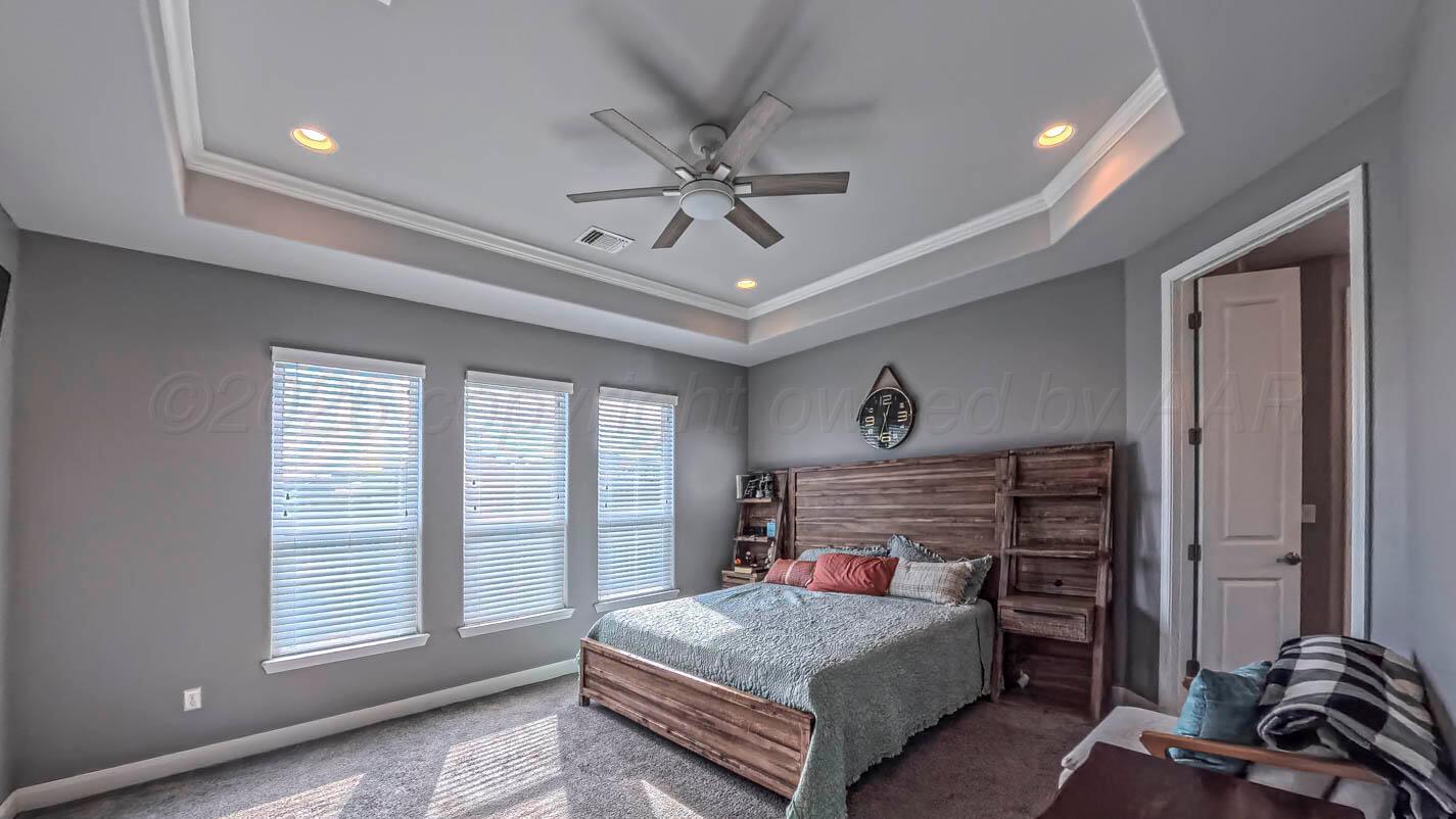 8903 Canton Court Amarillo, TX 79119 - Photo 14 of 26 a bedroom with a bed and wooden floor