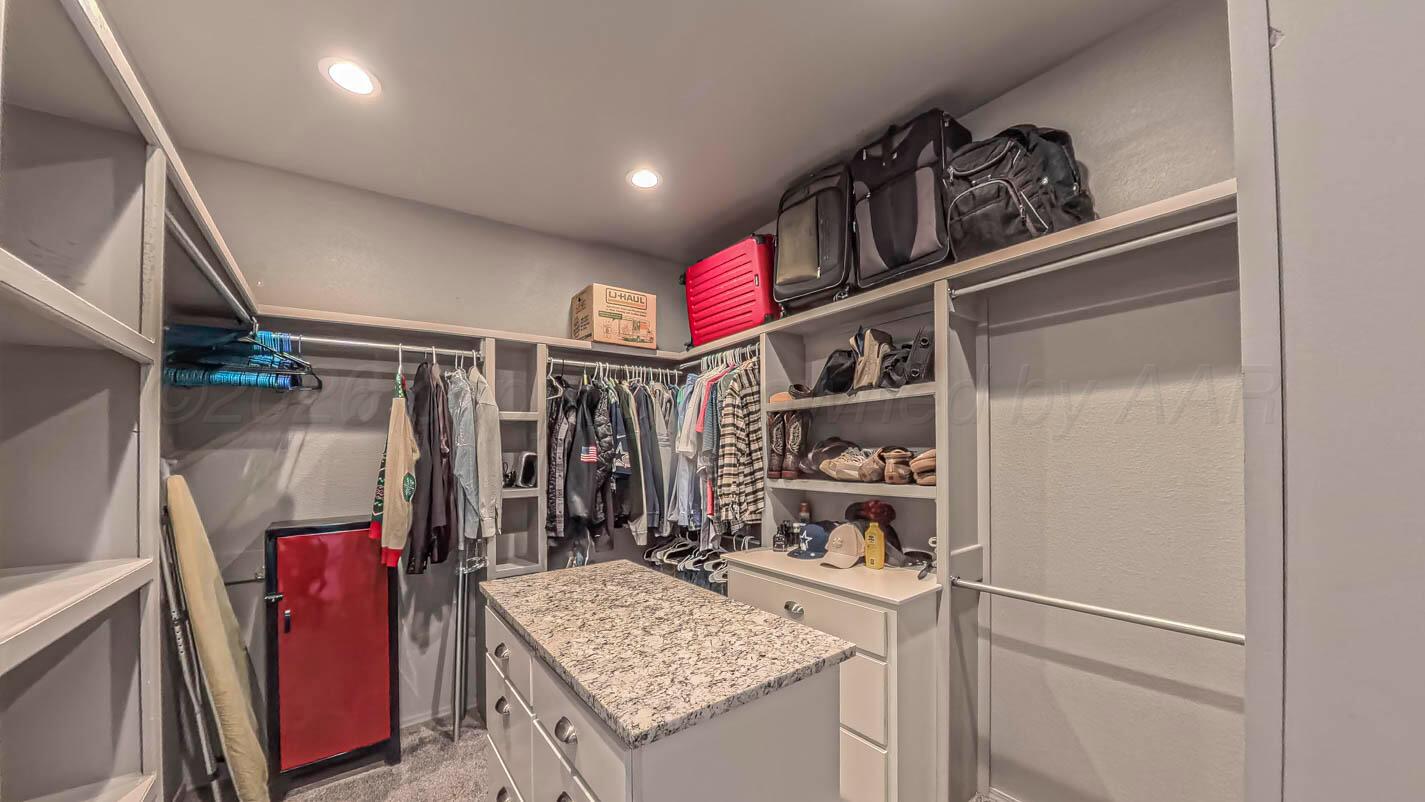 8903 Canton Court Amarillo, TX 79119 - Photo 19 of 26 a view of walk in closet with clothes and shoes
