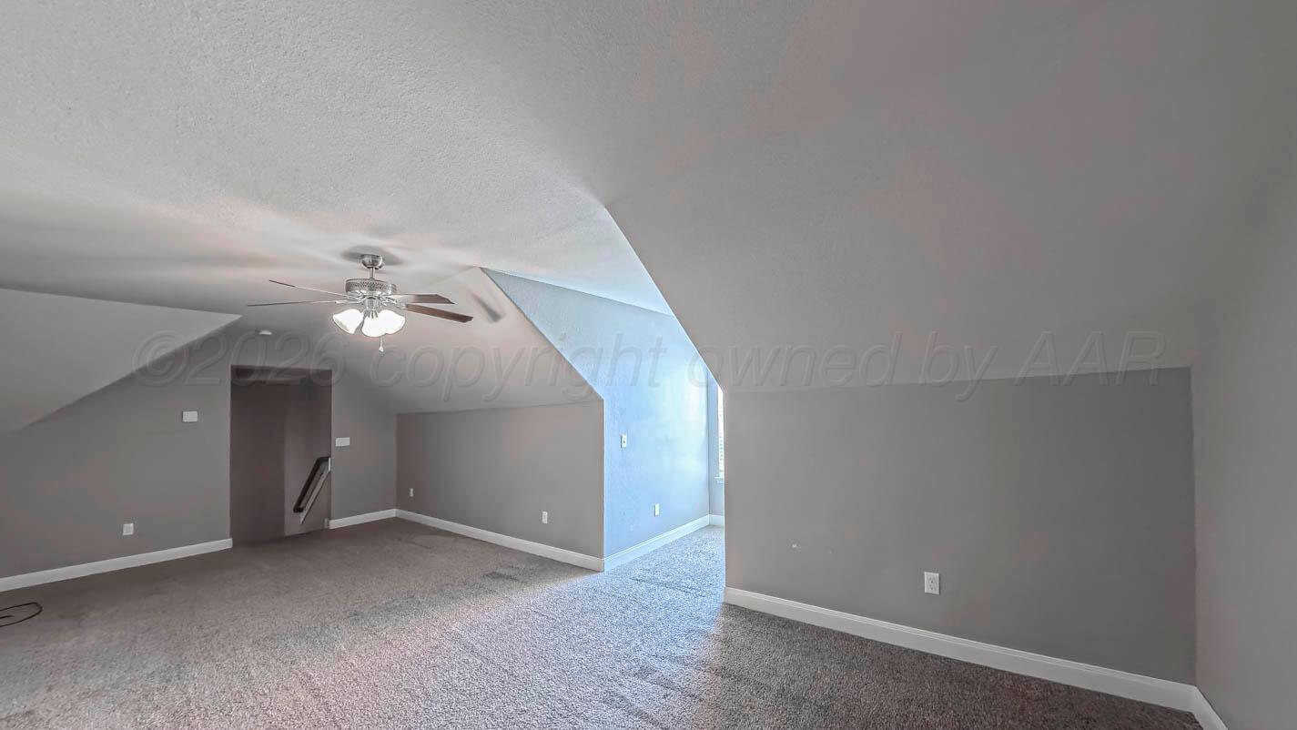 8903 Canton Court Amarillo, TX 79119 - Photo 21 of 26 an empty room with chandelier fan and windows
