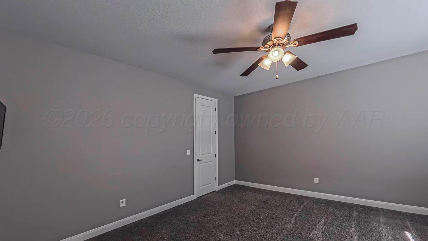 8903 Canton Court Amarillo, TX 79119 - Photo 22 of 26 an empty room with chandelier fan