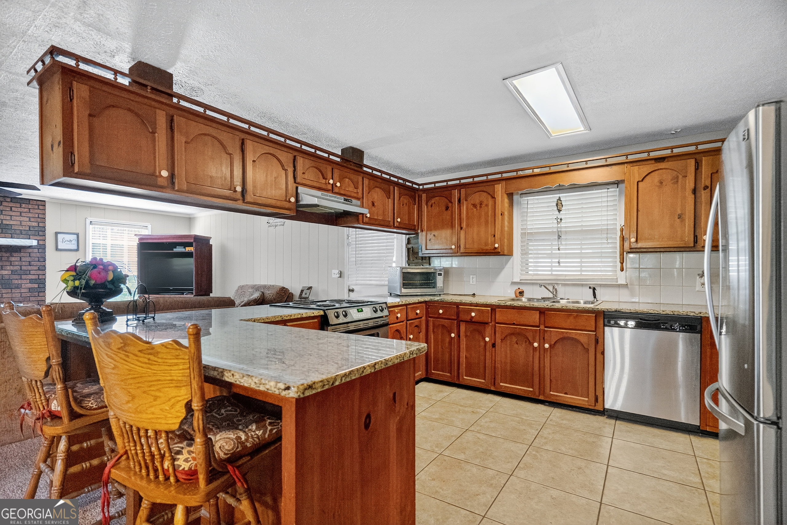 709 Vernon Ferry Road LaGrange, GA 30240 - Photo 12 of 27 a kitchen with stainless steel appliances granite countertop a sink and cabinets