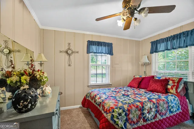a bedroom with a bed and a potted plant