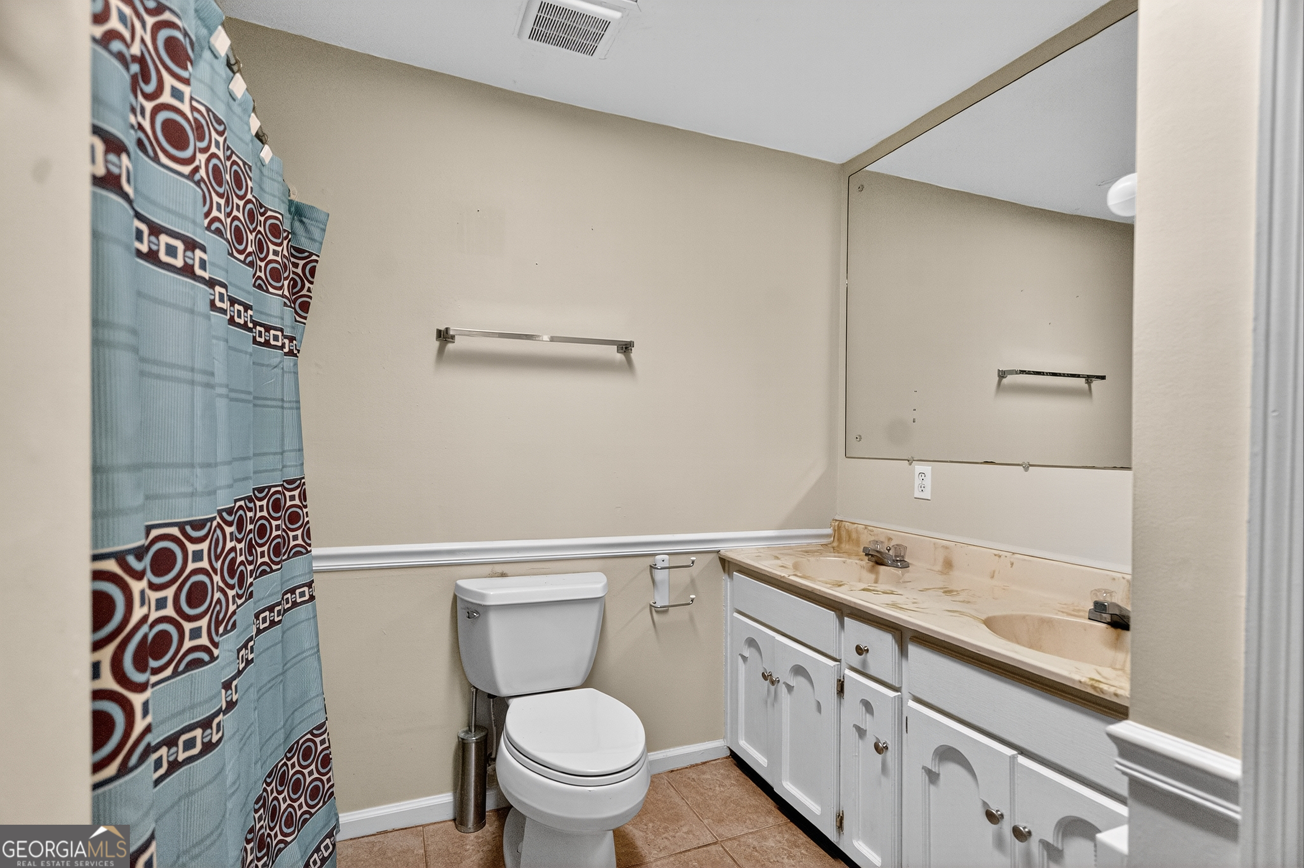 709 Vernon Ferry Road LaGrange, GA 30240 - Photo 14 of 27 a bathroom with a granite countertop toilet a sink and a mirror