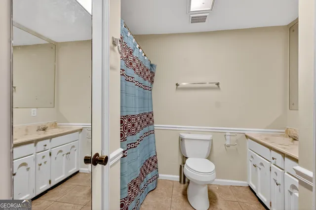 a bathroom with a toilet a sink and a shower