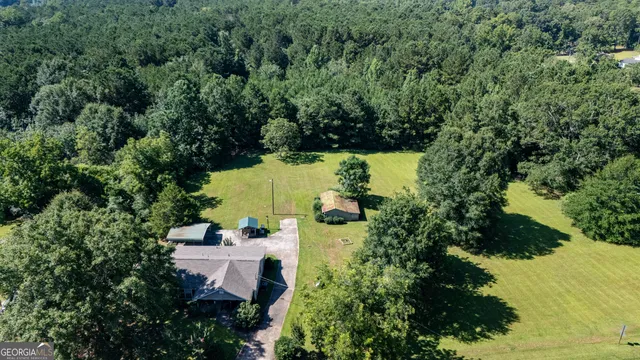an aerial view of a house with a yard