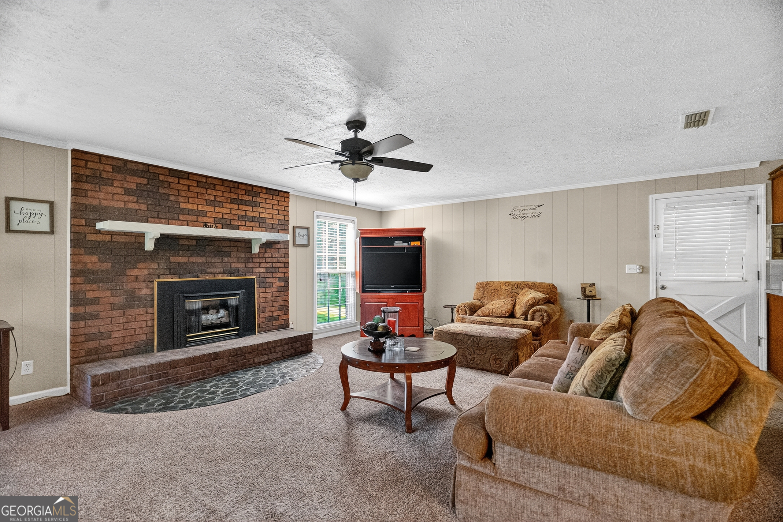 709 Vernon Ferry Road LaGrange, GA 30240 - Photo 8 of 27 a living room with furniture and a fireplace