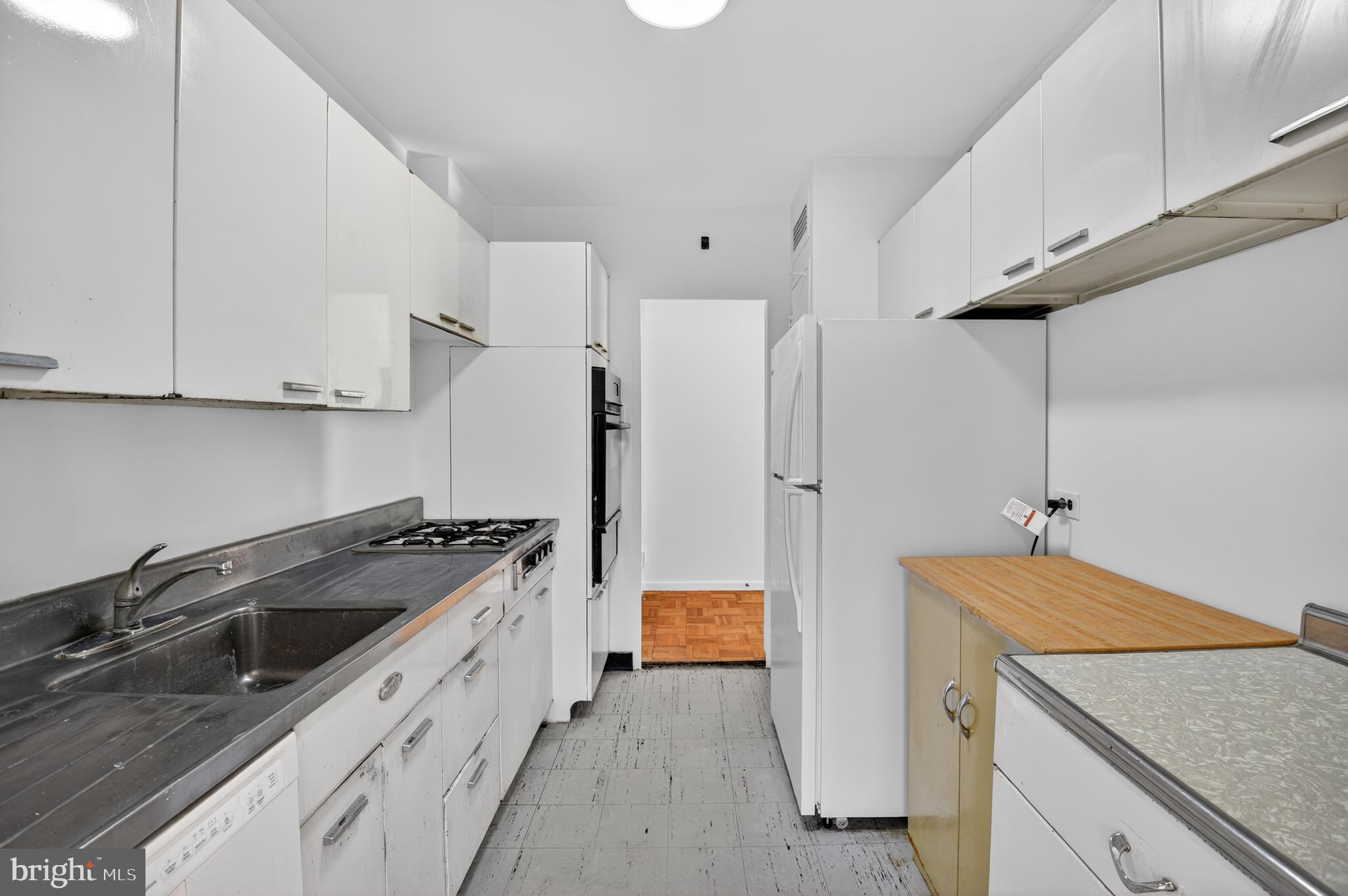 2475 Virginia Avenue Northwest, Unit 429 Washington, DC 20037 - Photo 11 of 27 a kitchen with stainless steel appliances granite countertop a sink and a refrigerator