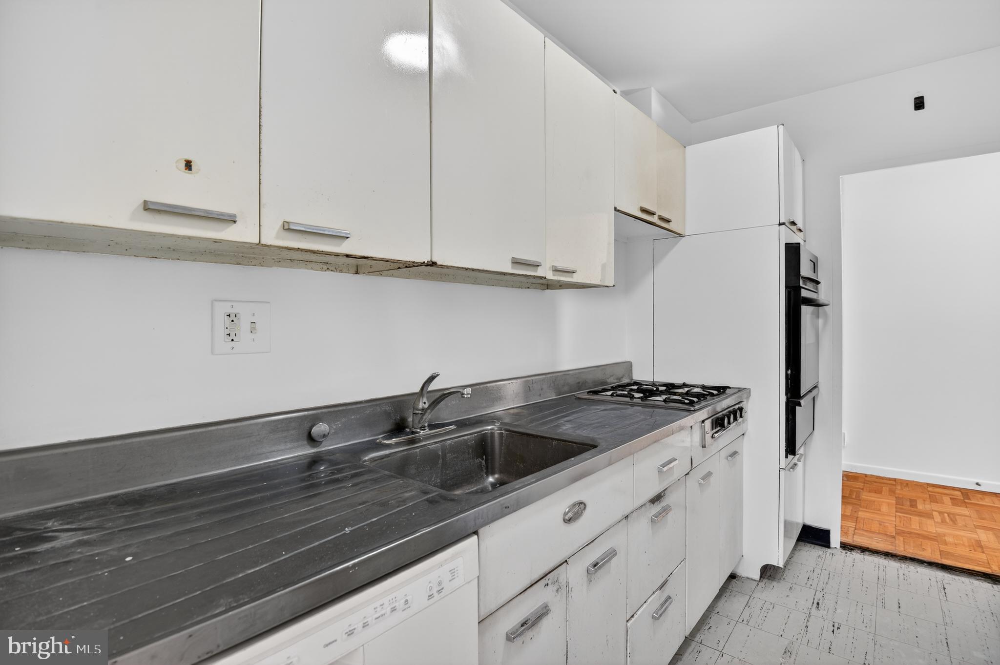 2475 Virginia Avenue Northwest, Unit 429 Washington, DC 20037 - Photo 12 of 27 a kitchen with granite countertop a sink and cabinets