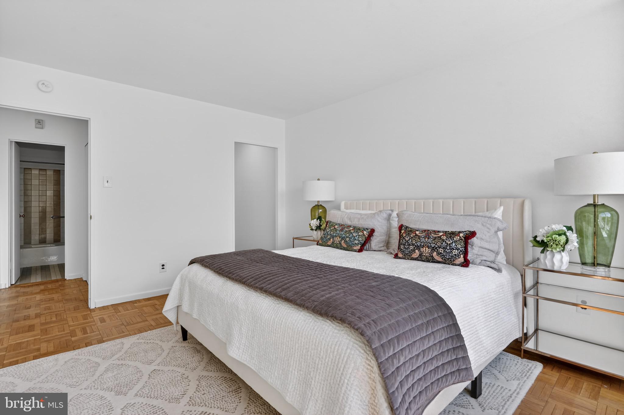 2475 Virginia Avenue Northwest, Unit 429 Washington, DC 20037 - Photo 13 of 35 a bedroom with a bed and painting on the wall