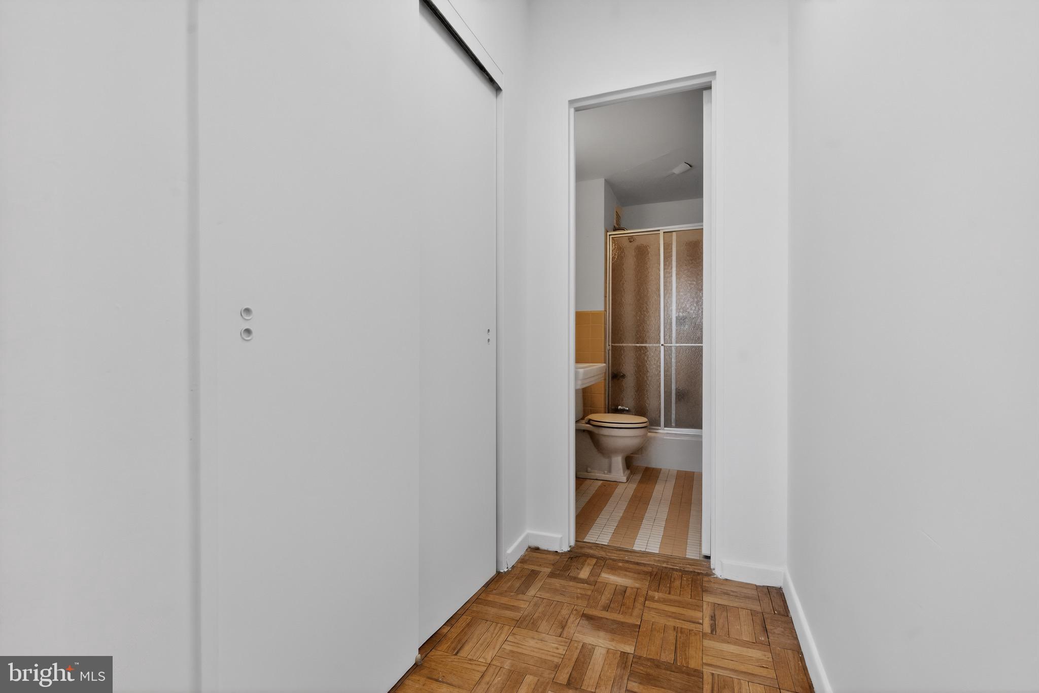 2475 Virginia Avenue Northwest, Unit 429 Washington, DC 20037 - Photo 14 of 35 a view of a hallway with wooden floor and a livingroom