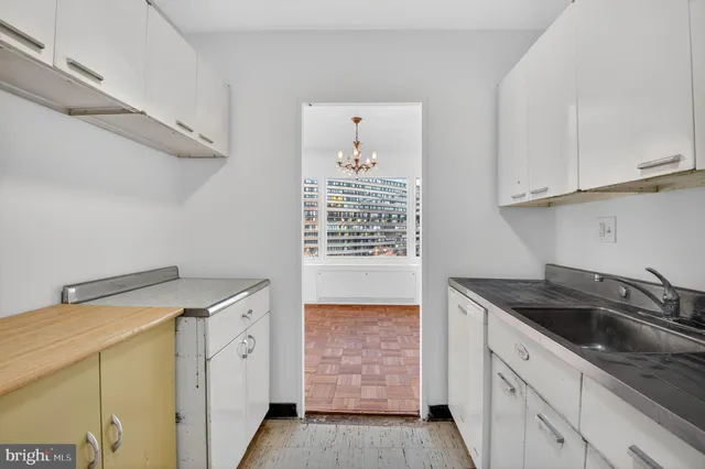 a kitchen that has a sink and a stove