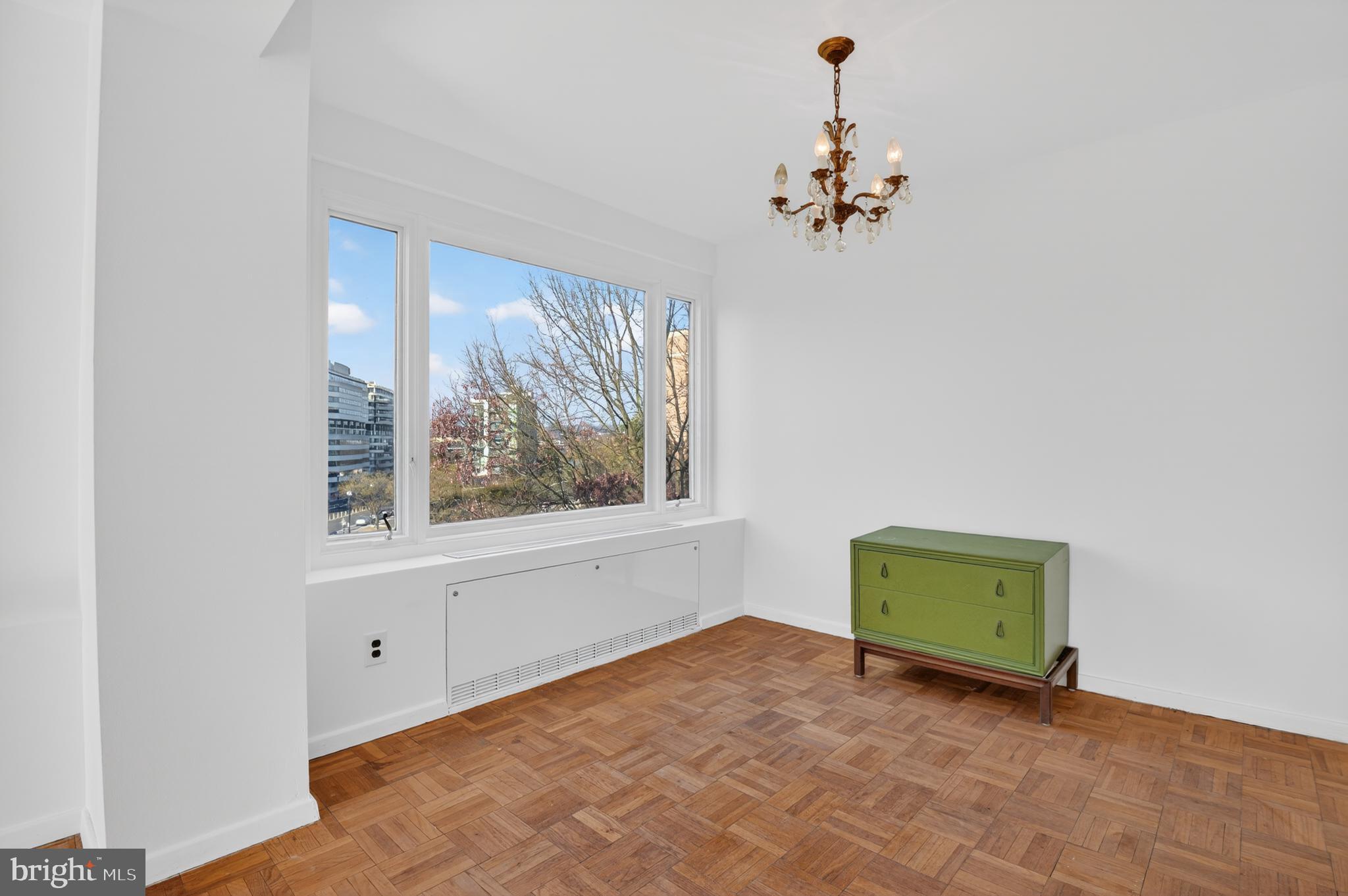 2475 Virginia Avenue Northwest, Unit 429 Washington, DC 20037 - Photo 16 of 27 an empty room with windows and chandelier