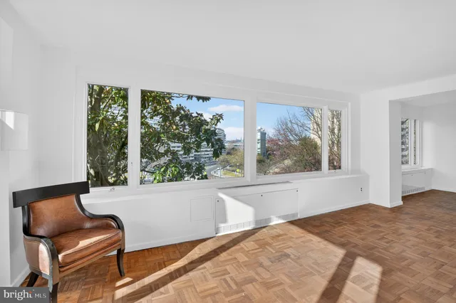 a living room with a large window and a couch