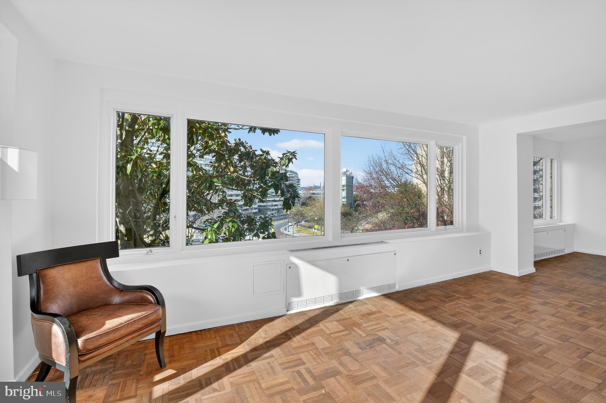2475 Virginia Avenue Northwest, Unit 429 Washington, DC 20037 - Photo 23 of 27 a living room with a large window and a couch