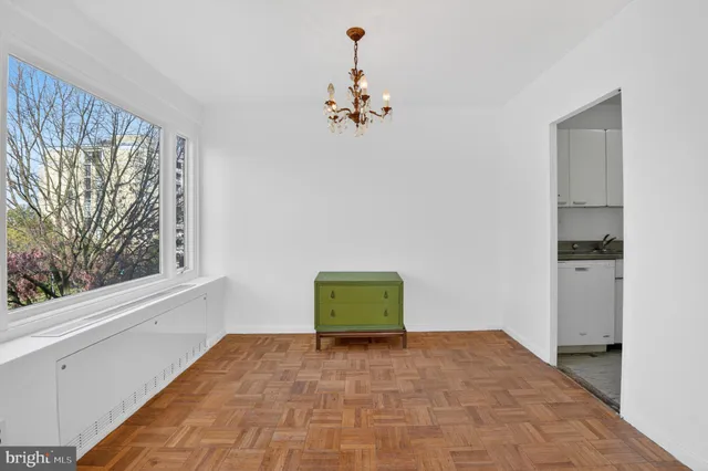 a room with a window and ceiling fan